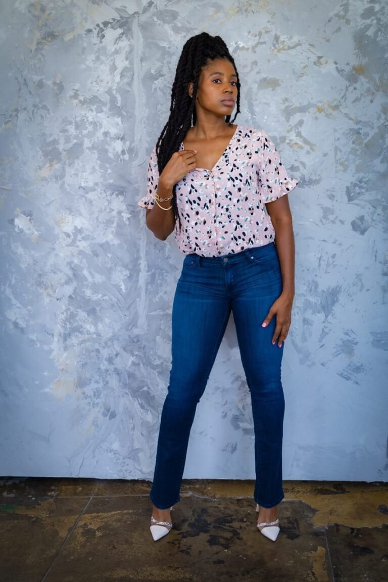 Reel cover: Lovett Love in a pink print top and jeans against a painted wall